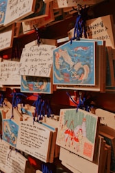 A bunch of cards are hanging on a wall