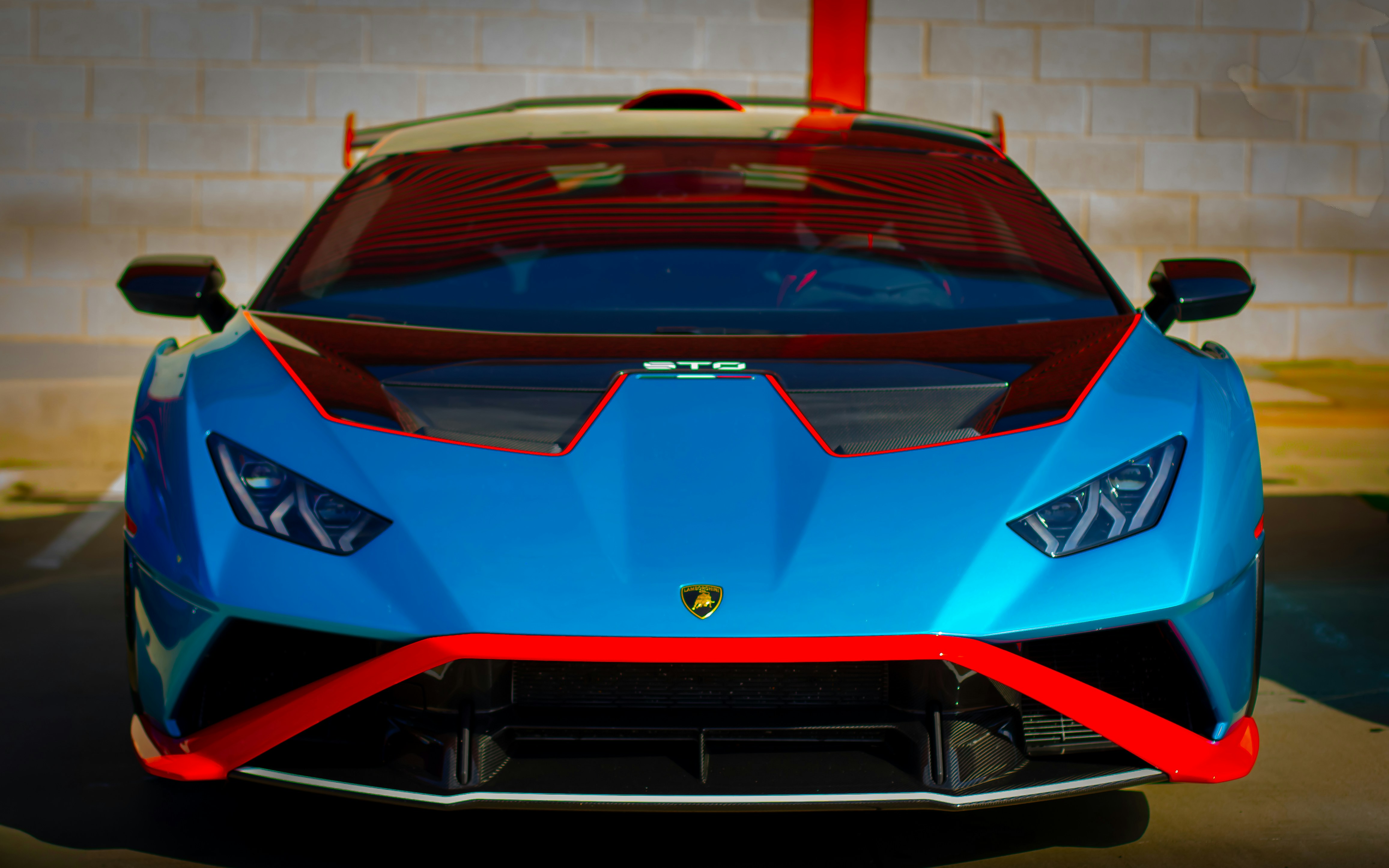 A blue sports car driving down a street