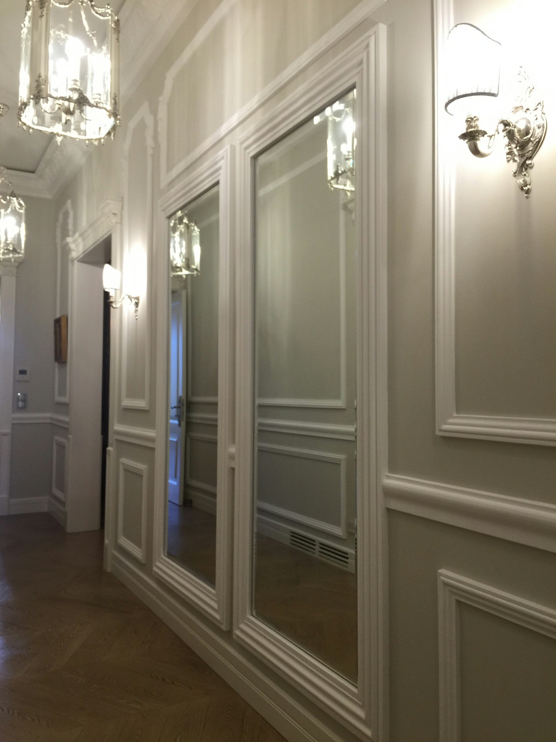 A hallway with a lot of mirrors on the wall