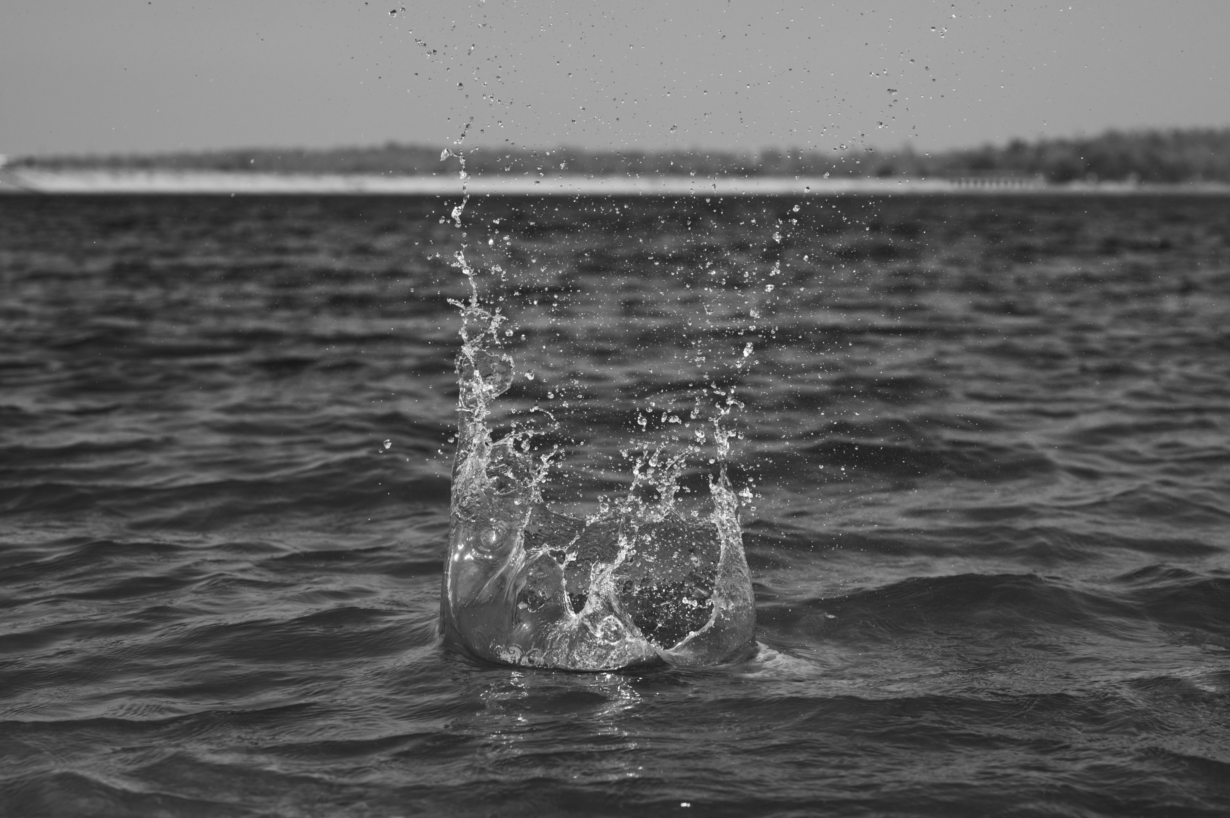 A black and white photo of a person splashing water