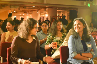 A group of people sitting next to each other