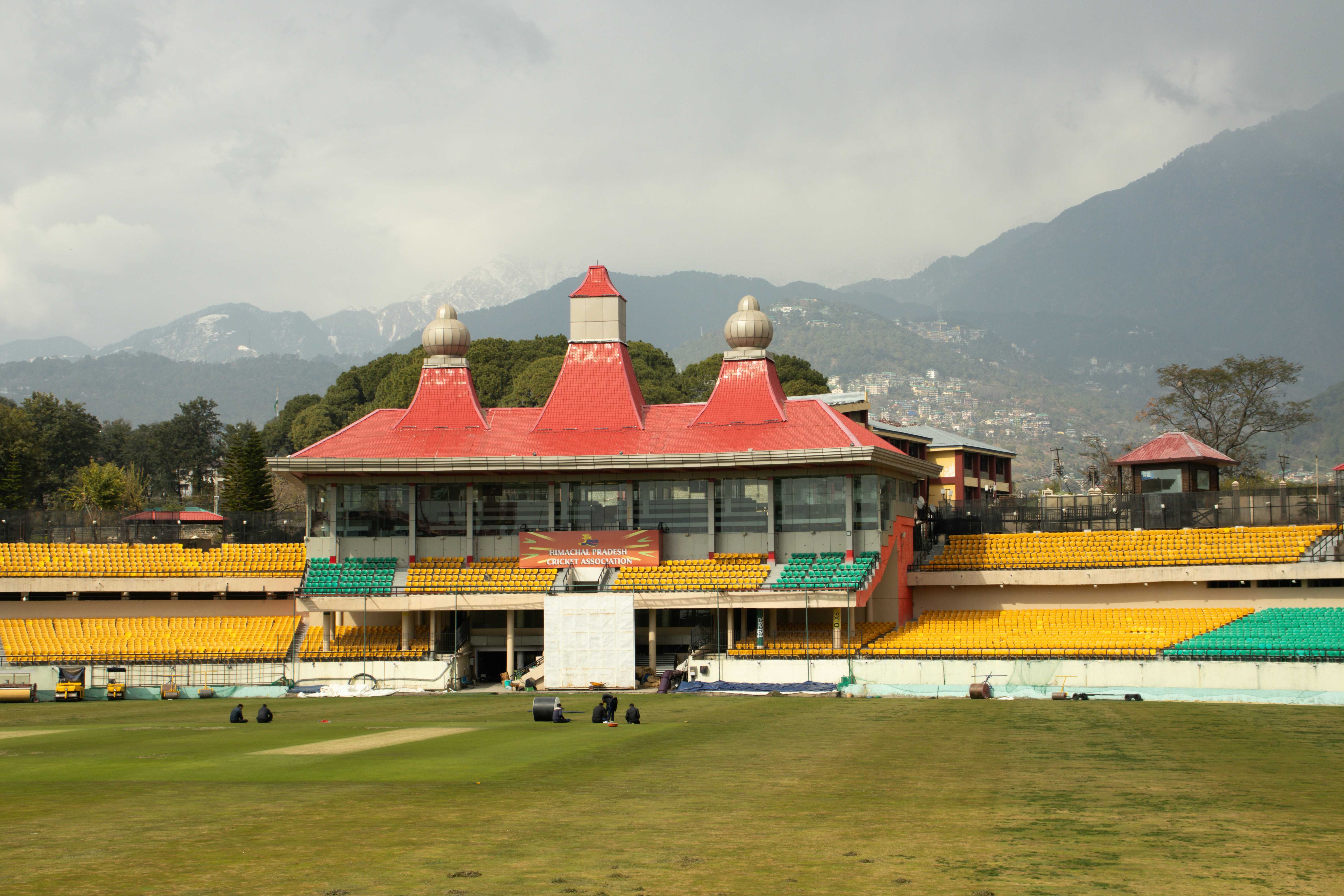 A view of a cricket stadium from across the field, 