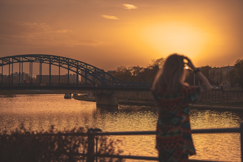 Woman admiring sunset on bridge