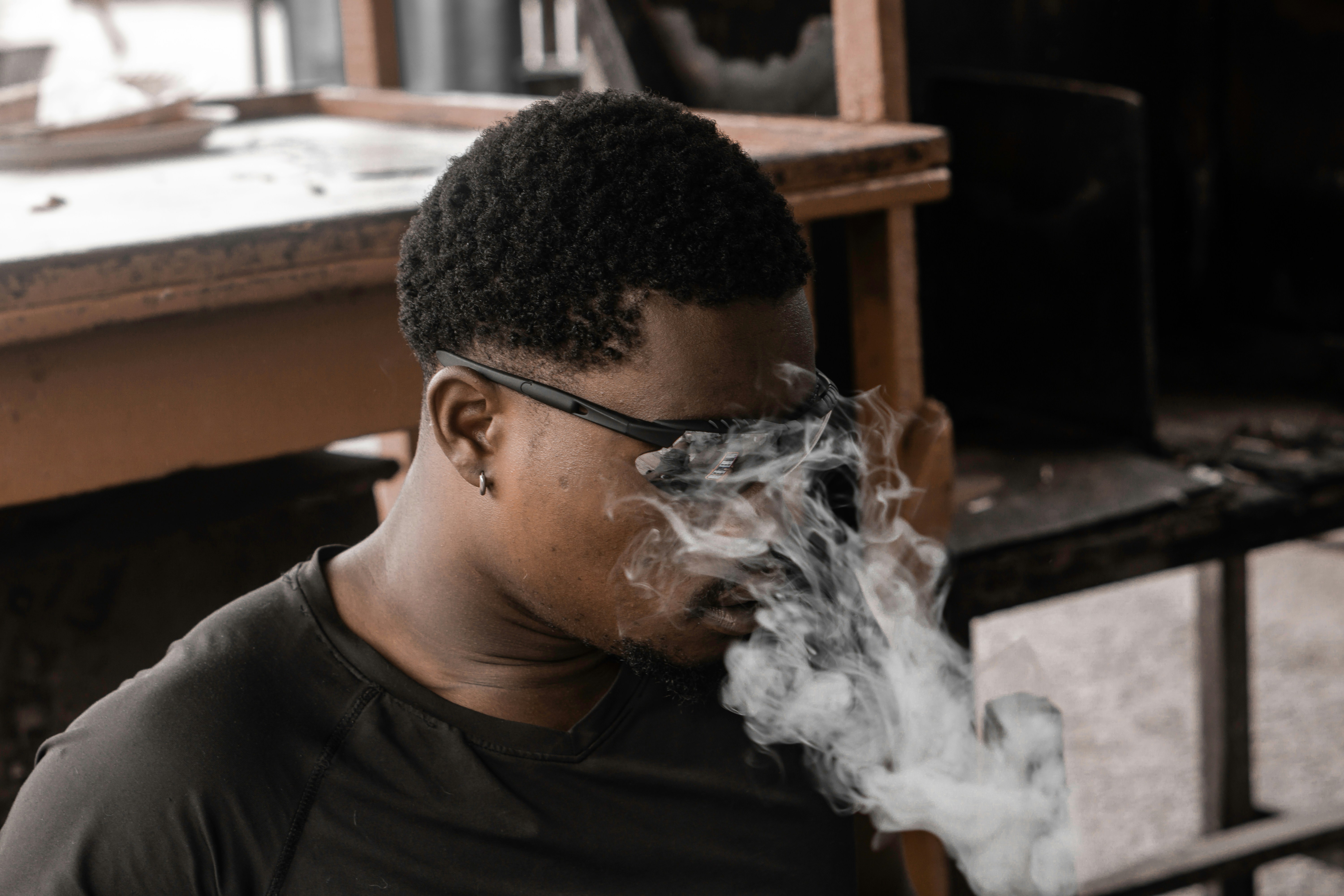 A man smoking a cigarette in a room