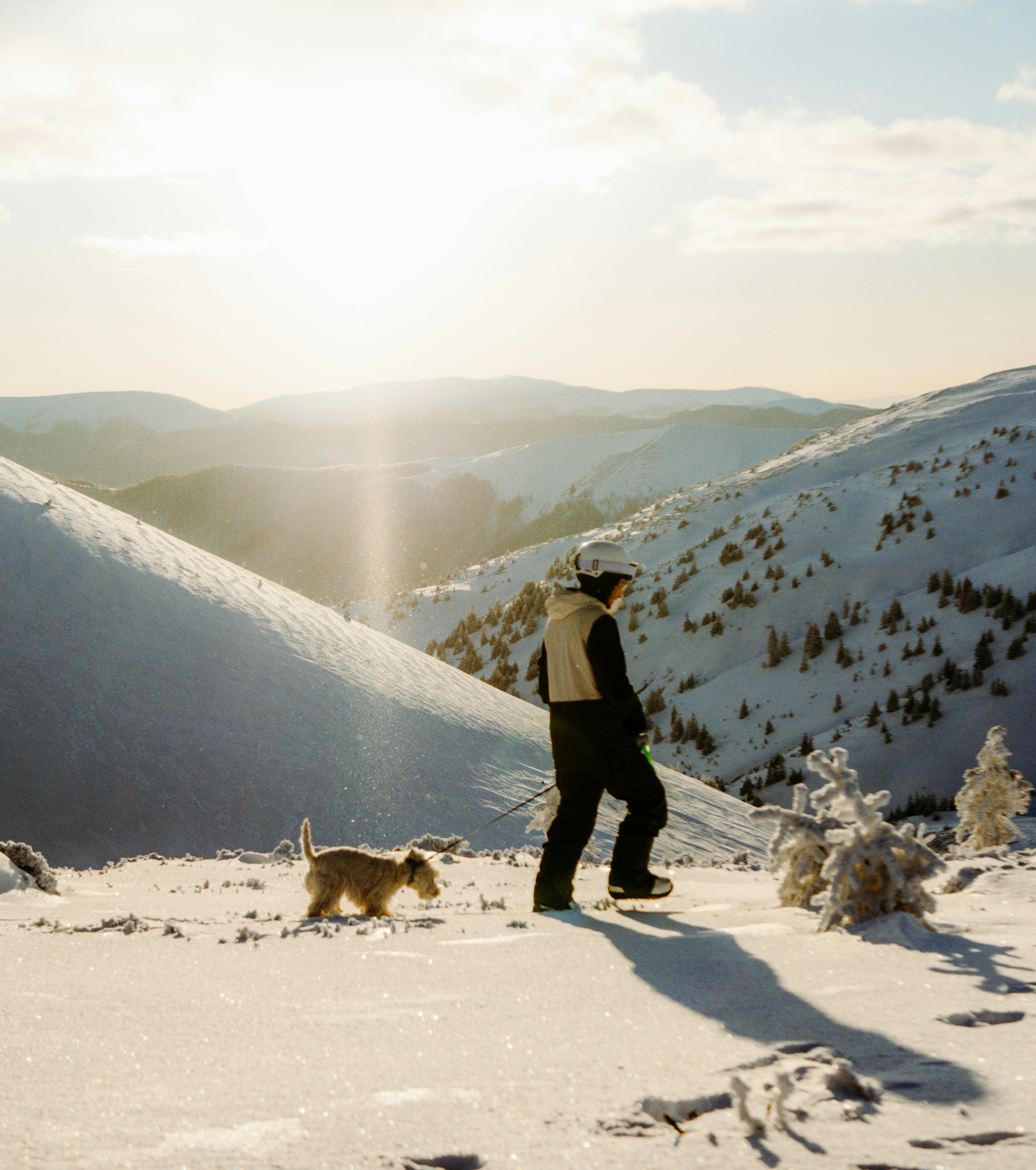 A man standing on top of a snow covered slope