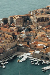 An aerial view of a city with boats in the water