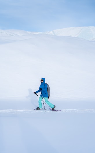 A person riding skis on a snowy surface