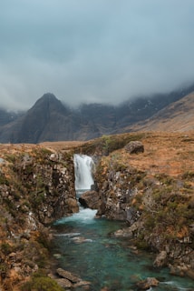 A small waterfall in the middle of a mountain