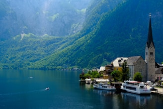 A small village on a lake surrounded by mountains