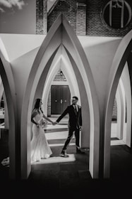 A man and a woman standing in front of a building