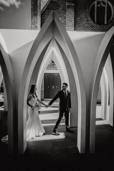 A man and a woman standing in front of a building