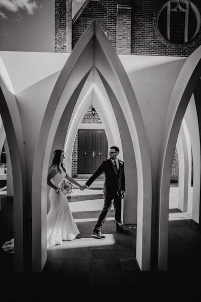 A man and a woman standing in front of a building