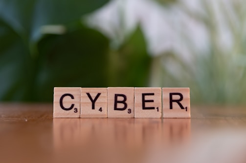 A scrabble type block spelling the word cyber