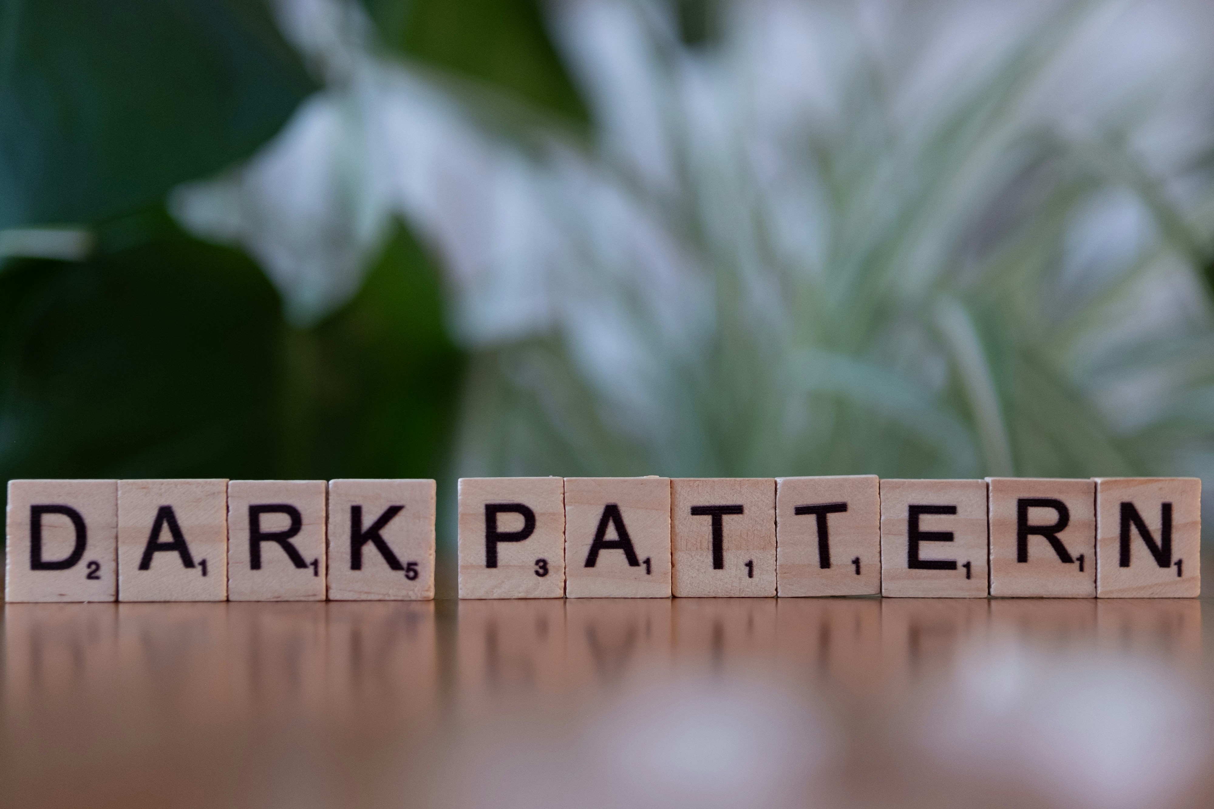 Scrabble tiles spelling out the word dark pattern