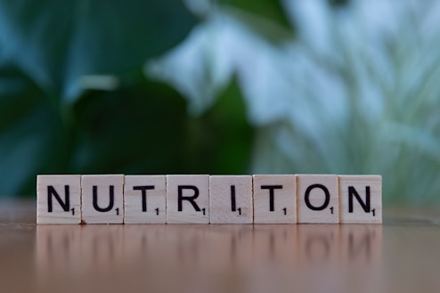 A wooden block spelling nutrition on a table