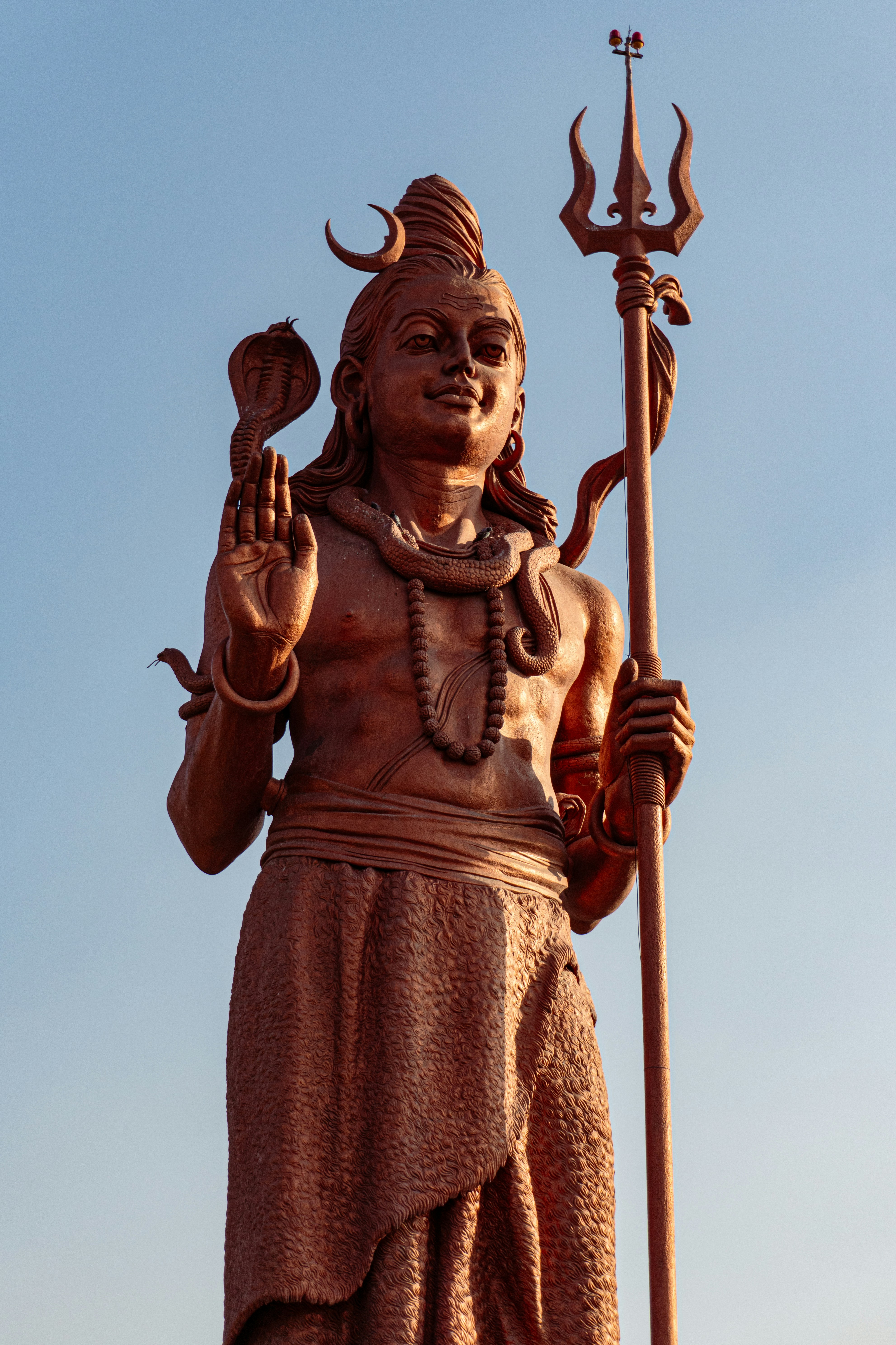 A statue of a hindu god holding a staff