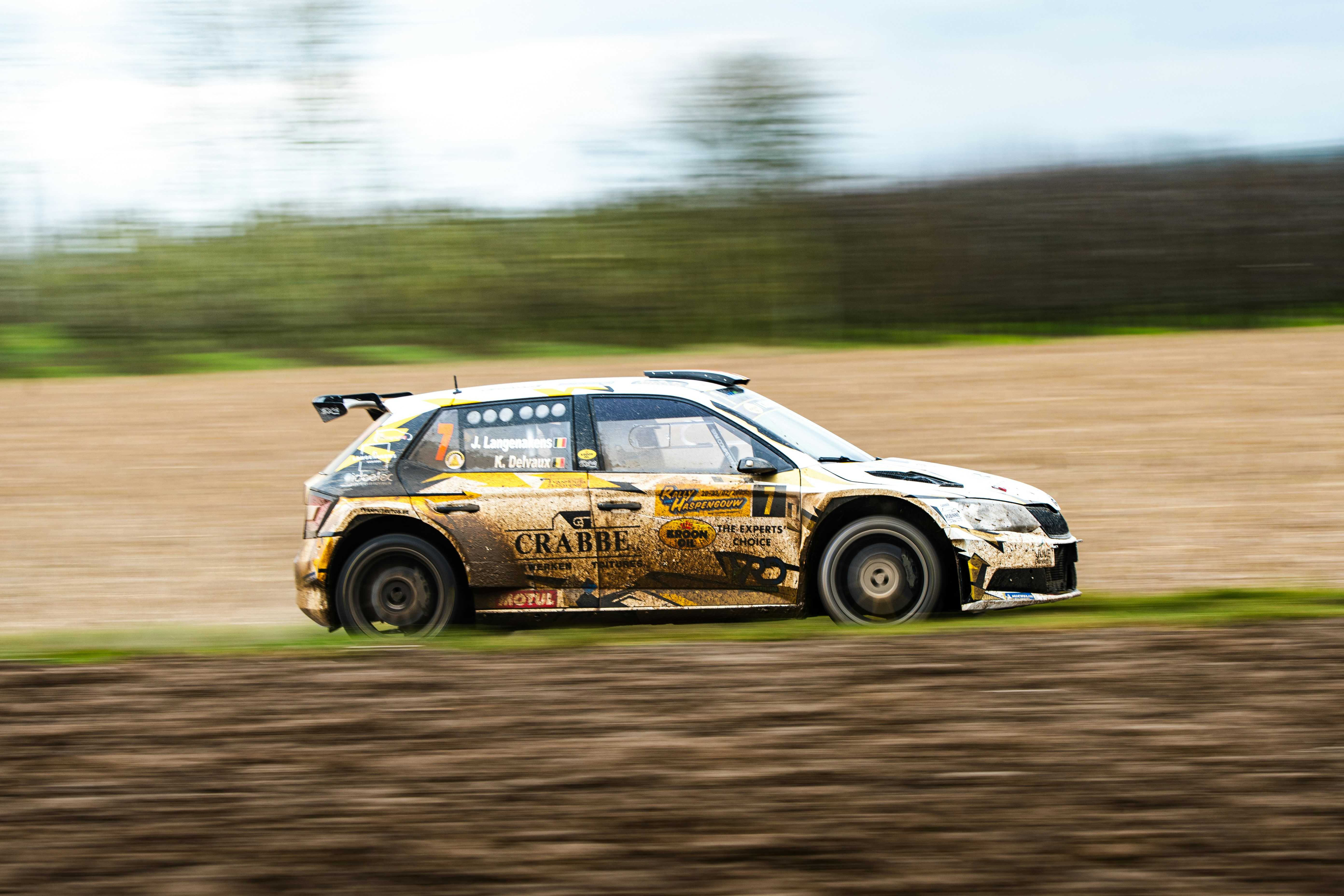 A rally car driving on a dirt road