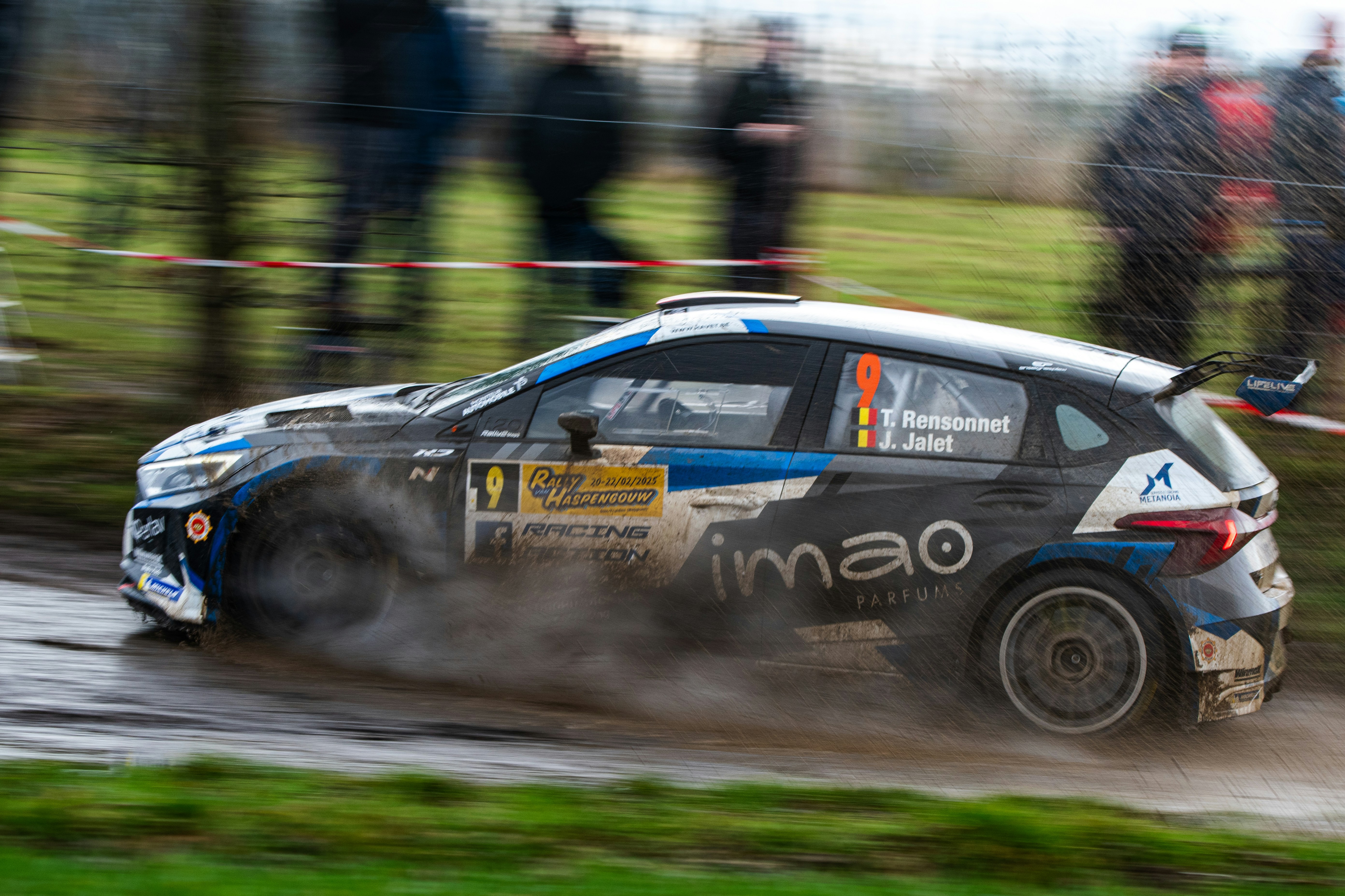 A small car driving down a dirt road