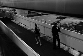 A couple of people standing on a train platform