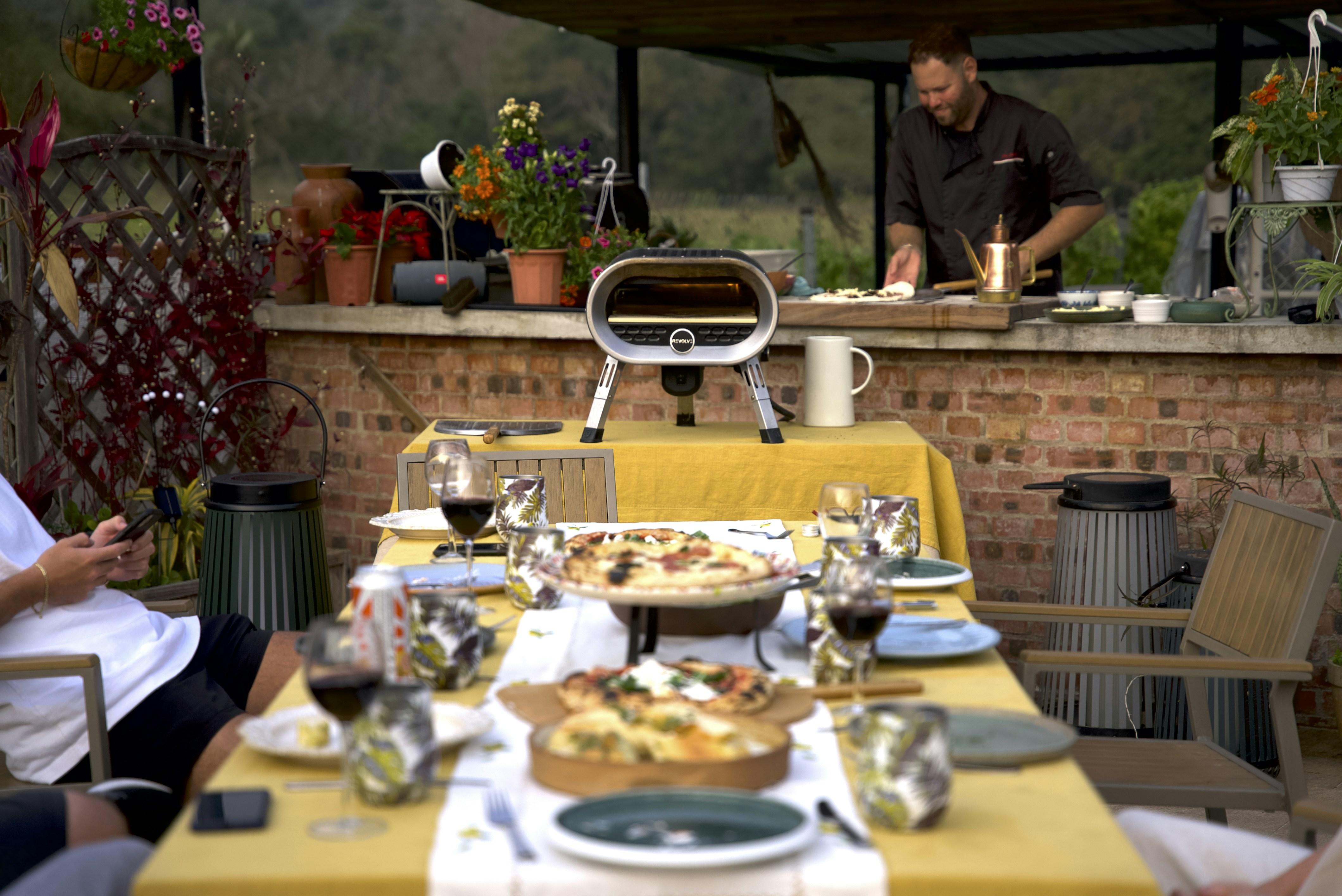 A group of people sitting around a table with food on it