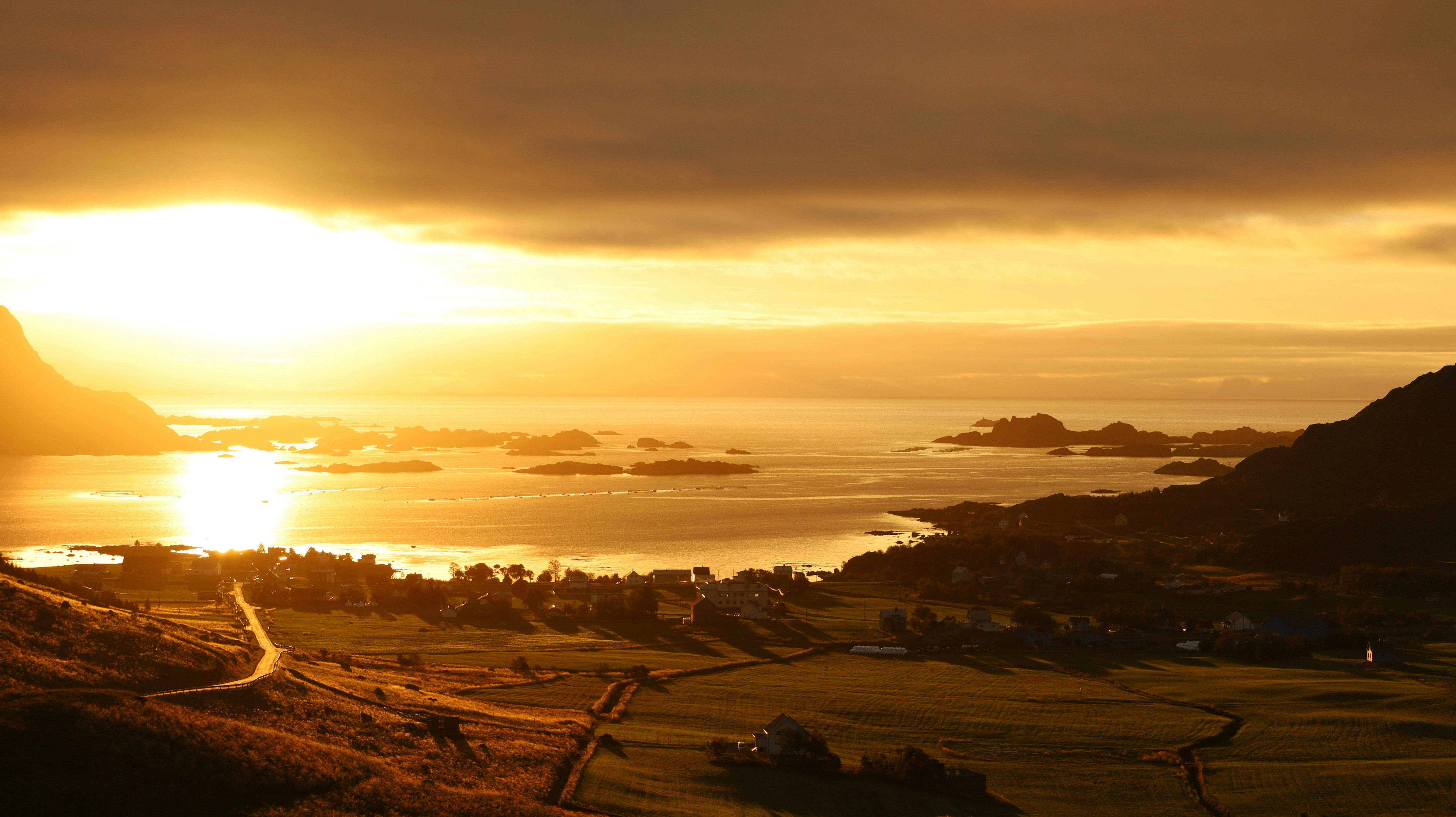 A scenic view of a lush green golf course at a private country club during sunset