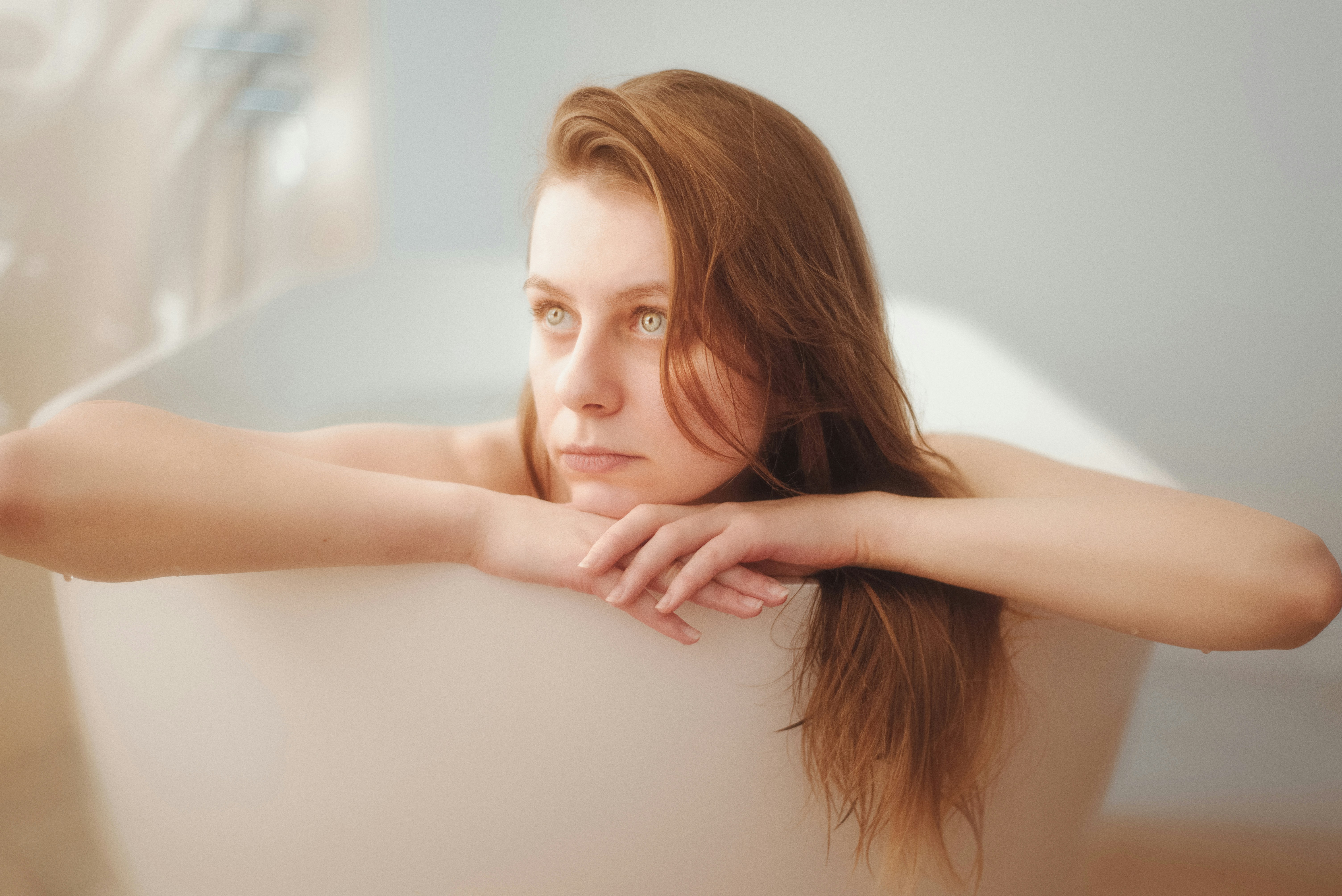 person relaxing in a warm bath - alleviate sore muscles after workout