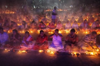 A group of people sitting around a fire pit