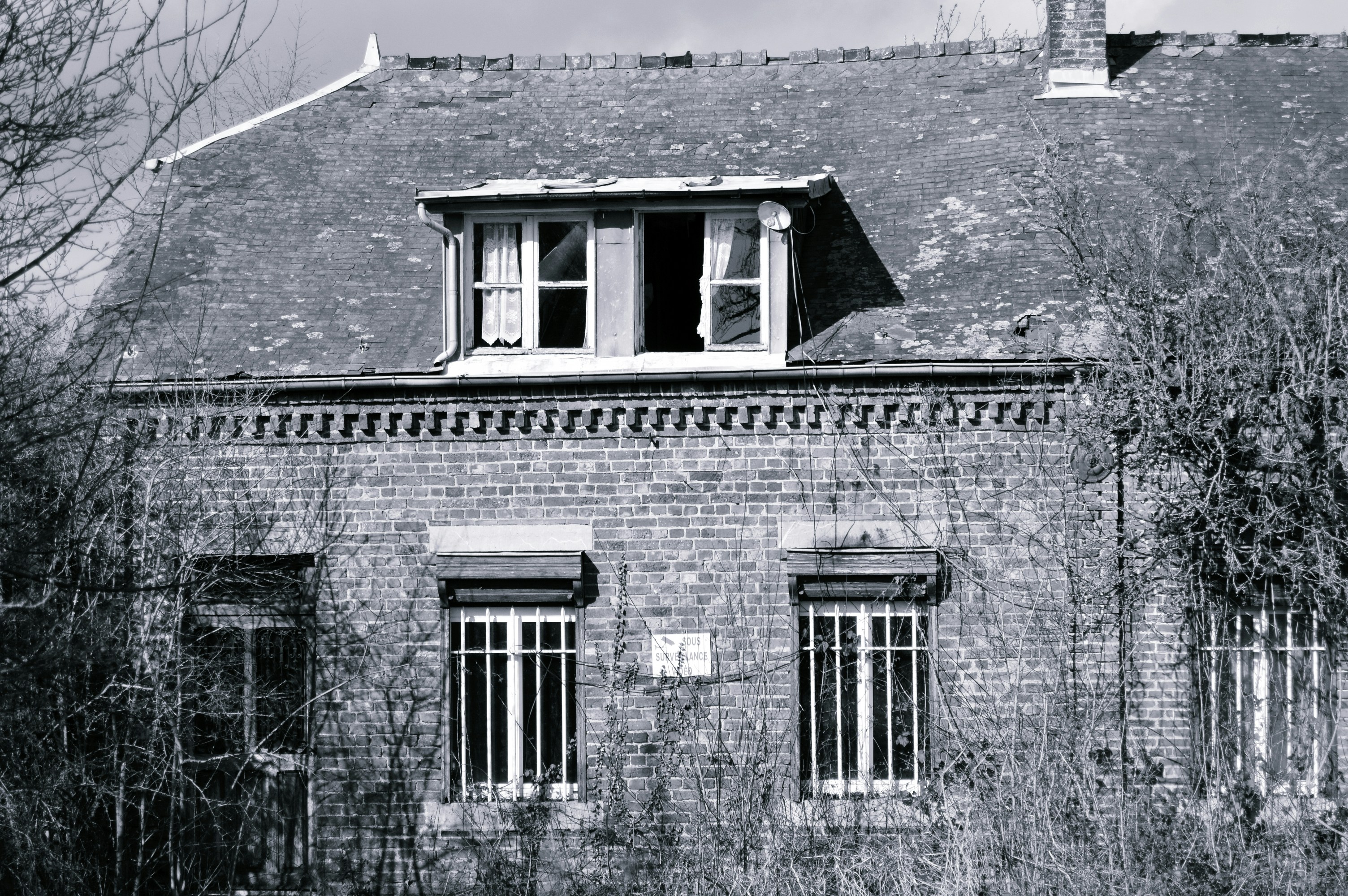 A black and white photo of an old brick building