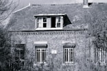 A black and white photo of an old brick building