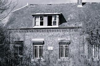 A black and white photo of an old brick building