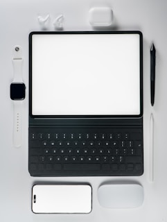 A laptop computer sitting on top of a white table