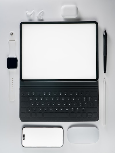 A laptop computer sitting on top of a white table