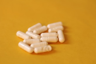 A pile of pills sitting on top of a yellow table