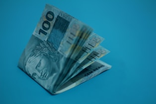 A bunch of money sitting on top of a blue surface