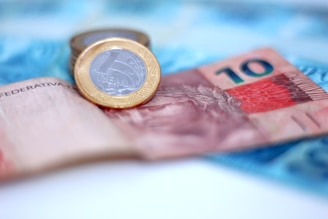 A coin sitting on top of a pile of money