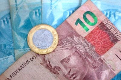 A close up of a money bill with a coin on top of it