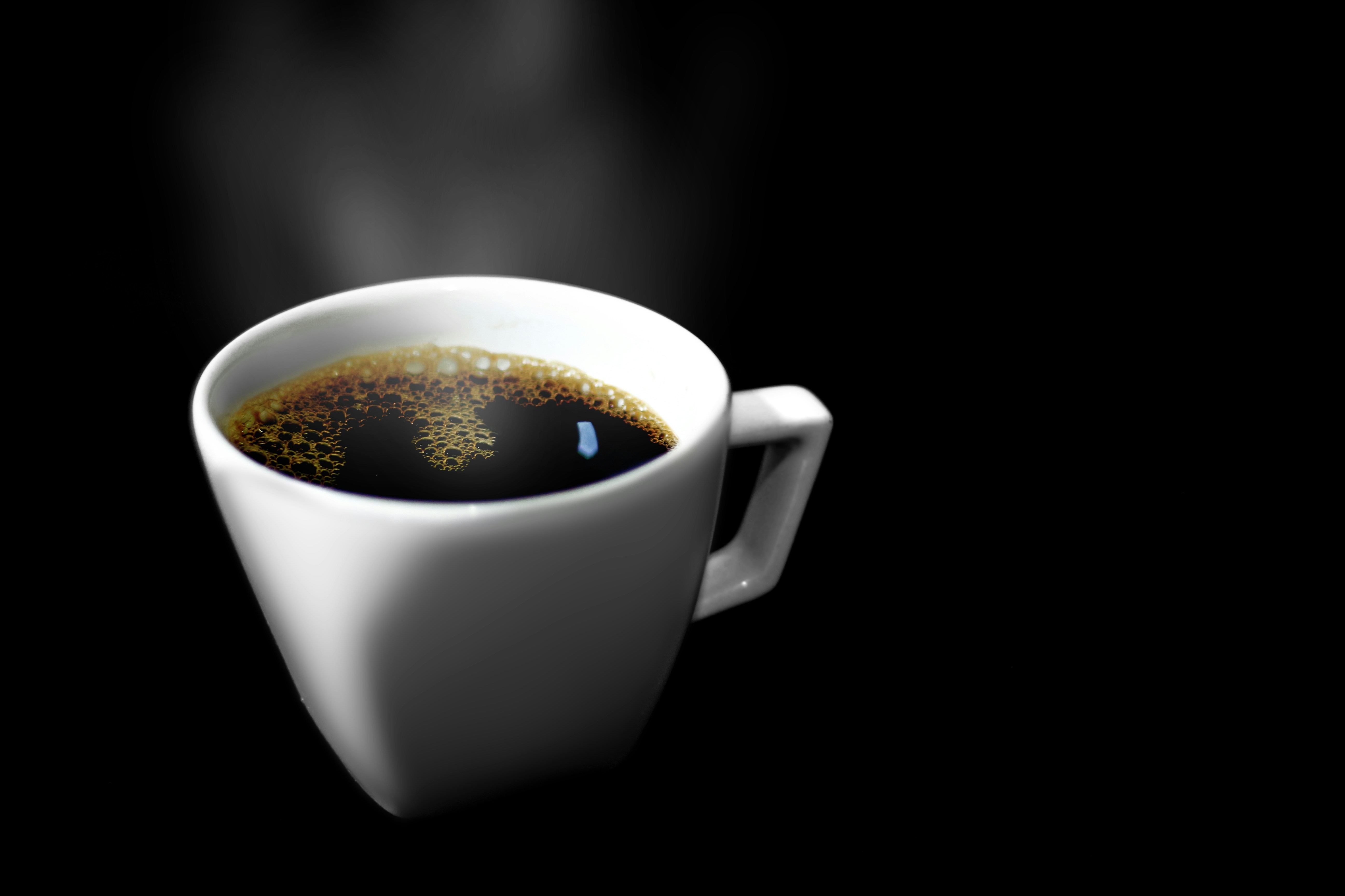 A cup of coffee with steam rising out of it