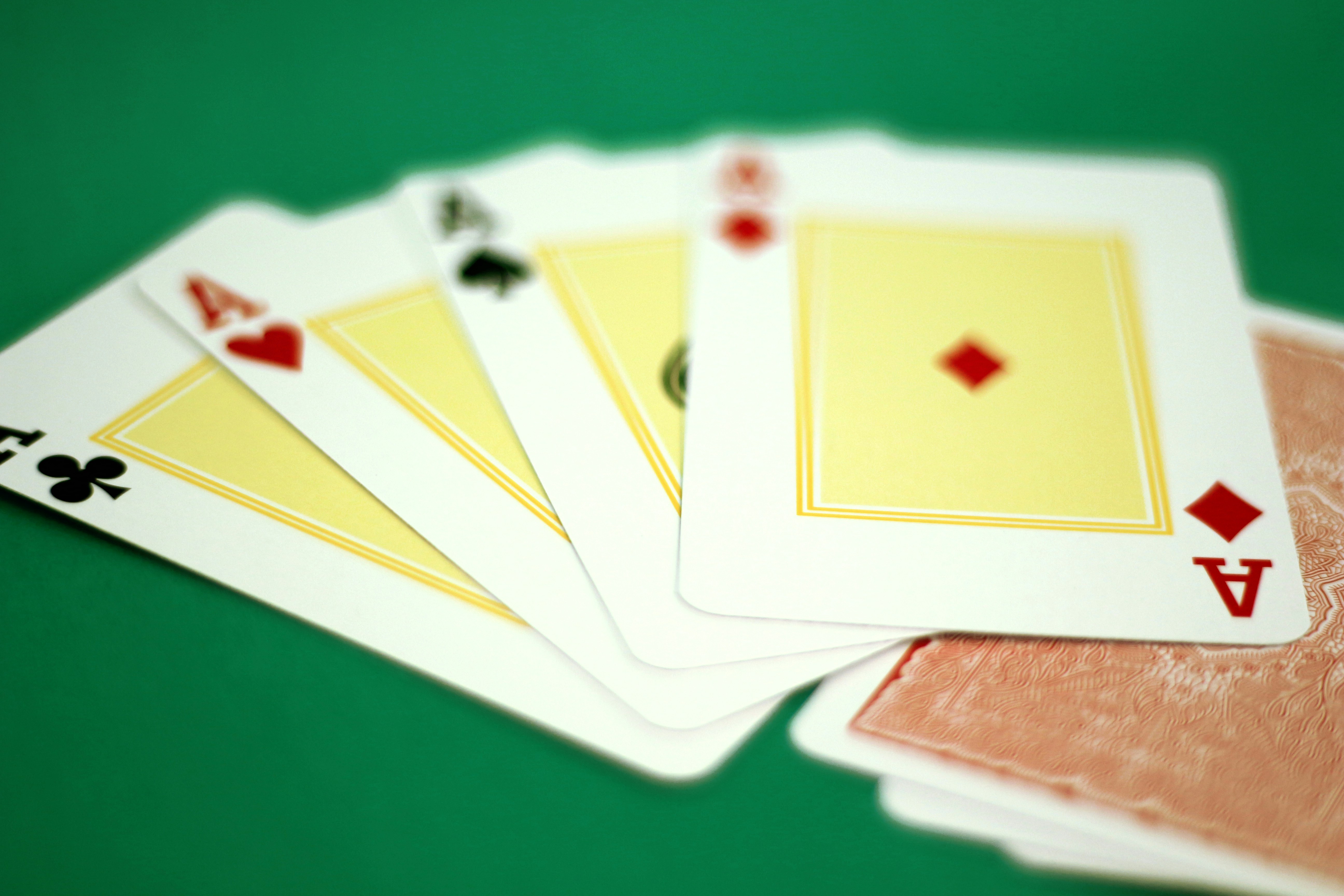 Four of a kind of playing cards on a green table