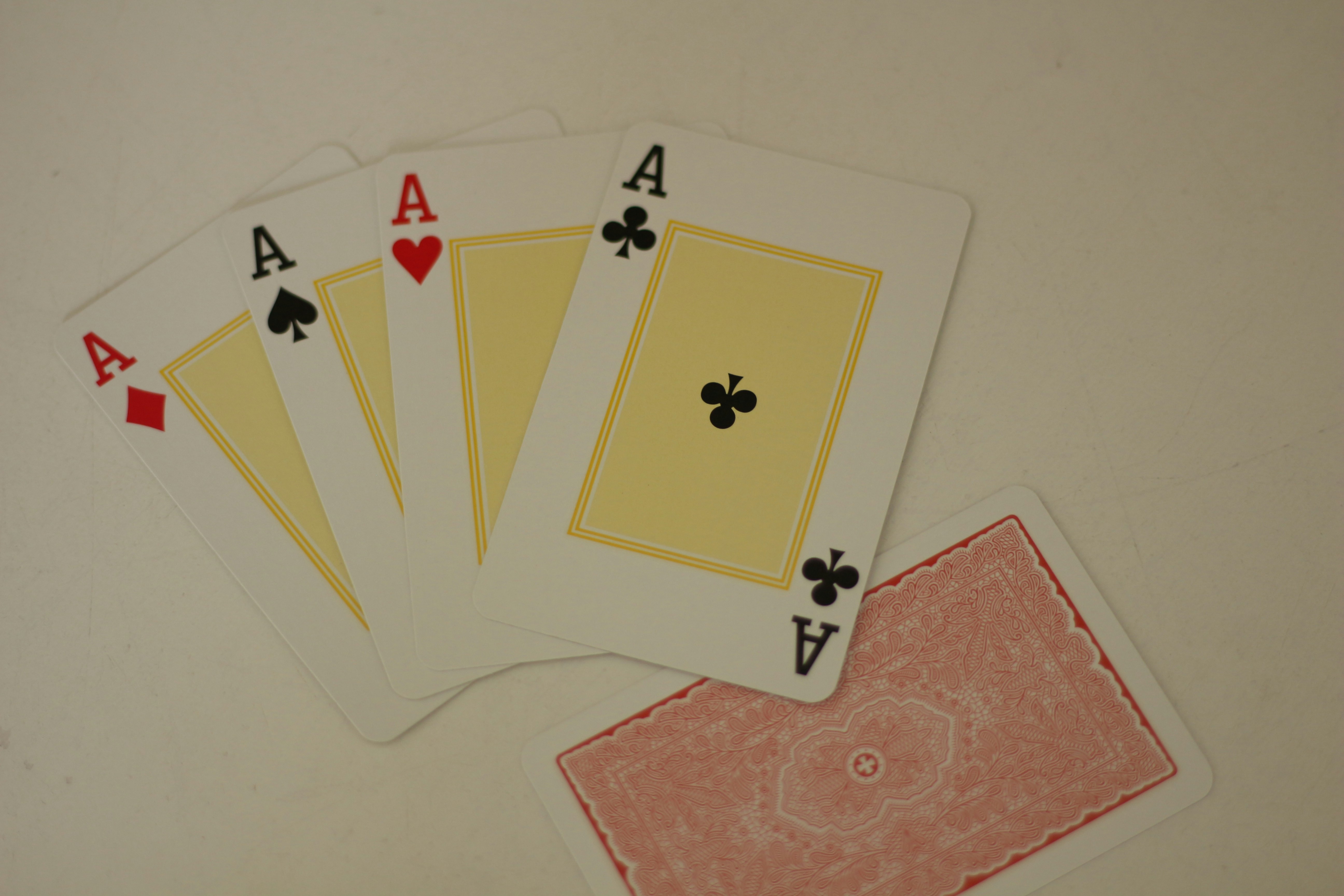Four of a kind of playing cards sitting on top of a table