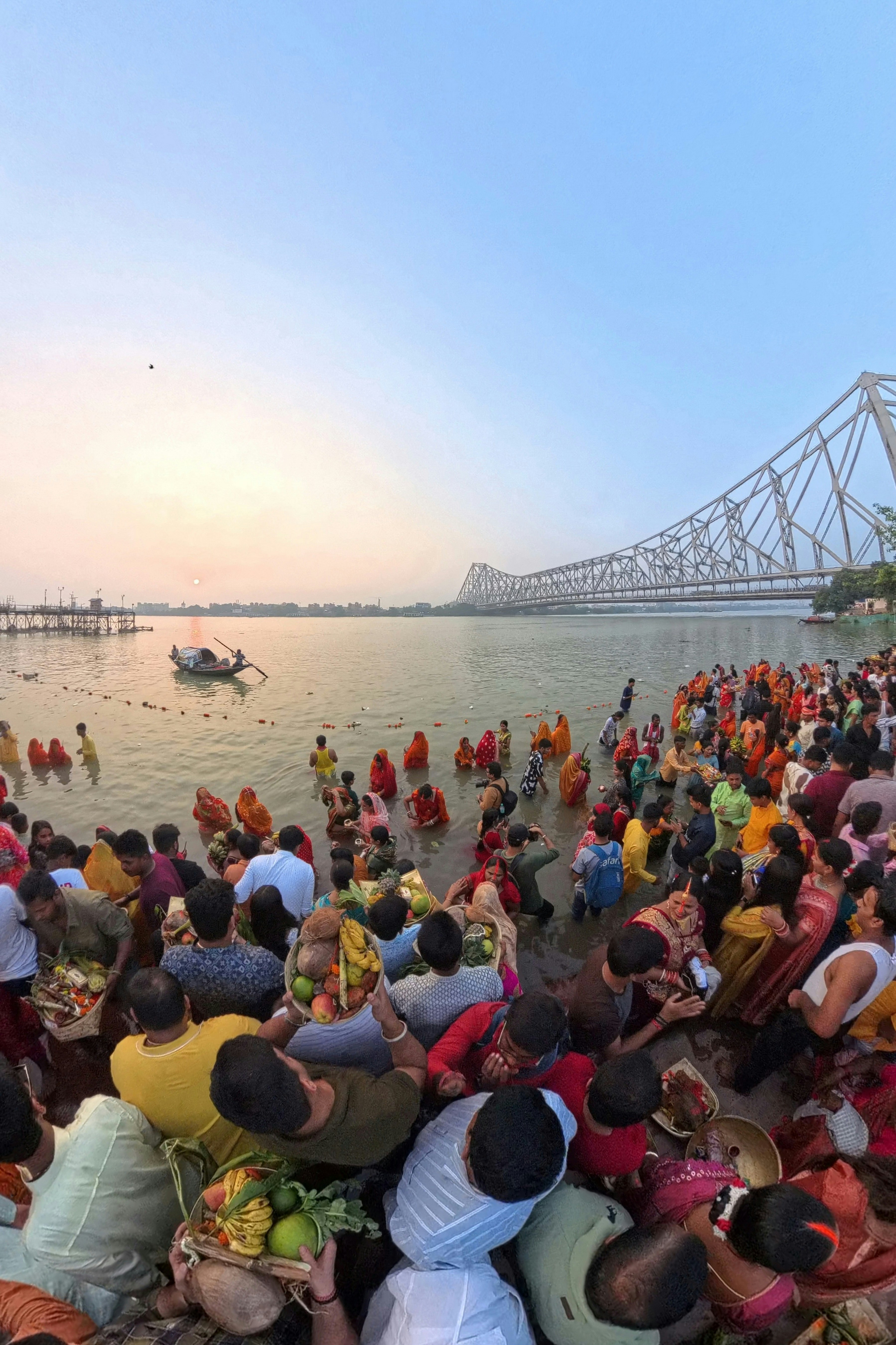 A large group of people standing in front of a body of water