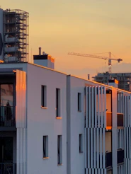 A view of a building with a crane in the background
