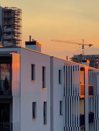 A view of a building with a crane in the background