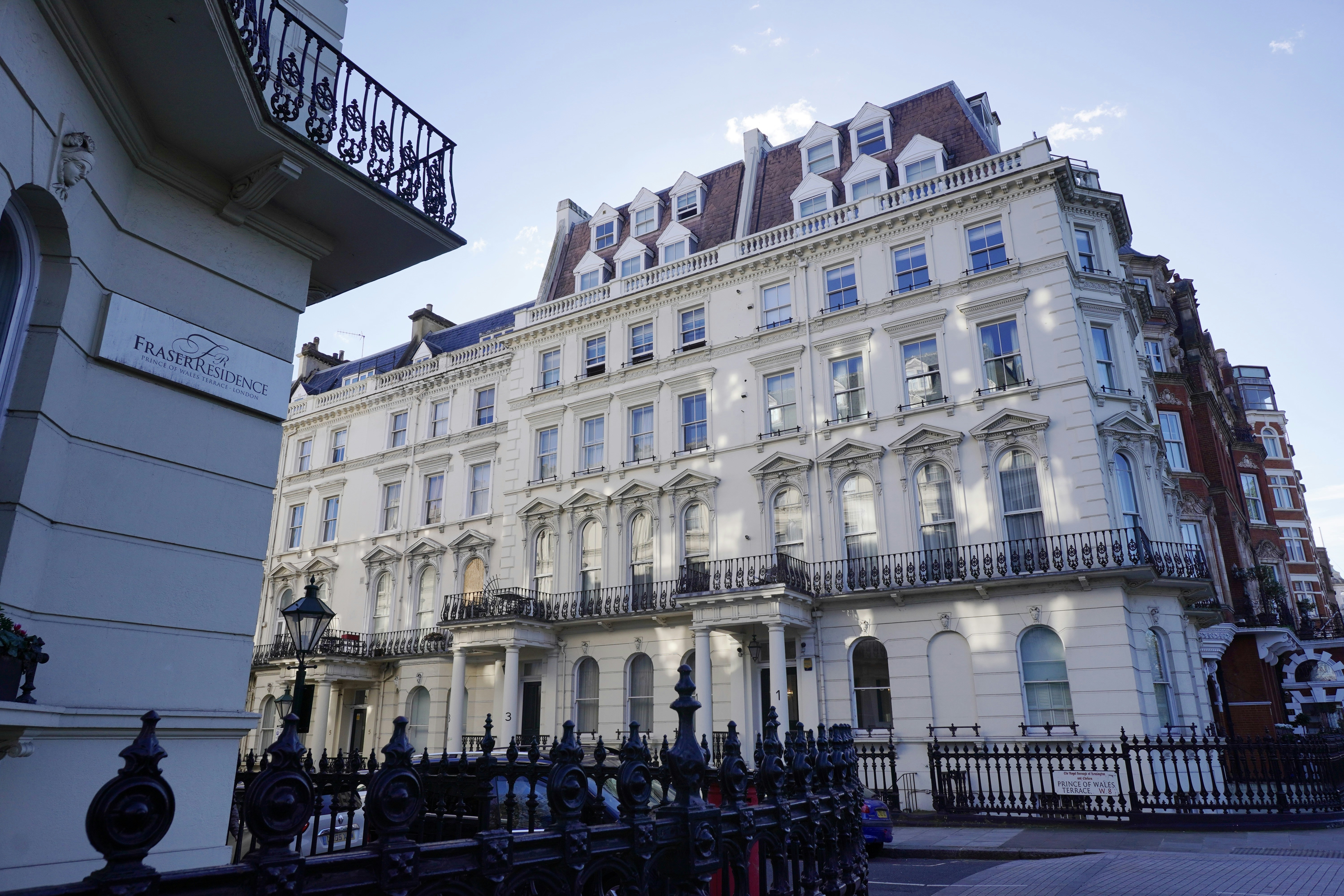A large white building with many windows and balconies