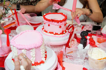 A group of people standing around a table with a cake