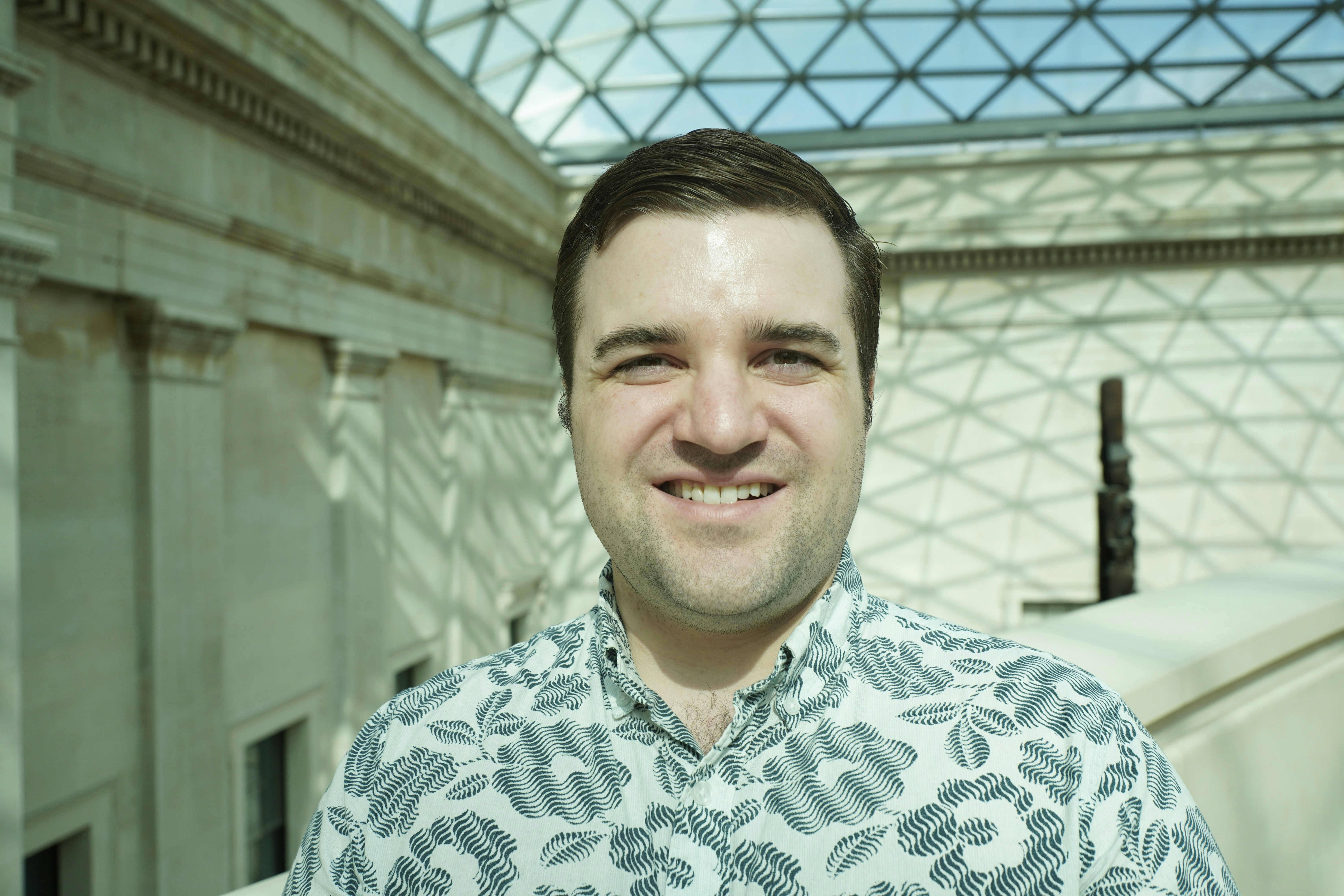 A man standing in front of a glass ceiling