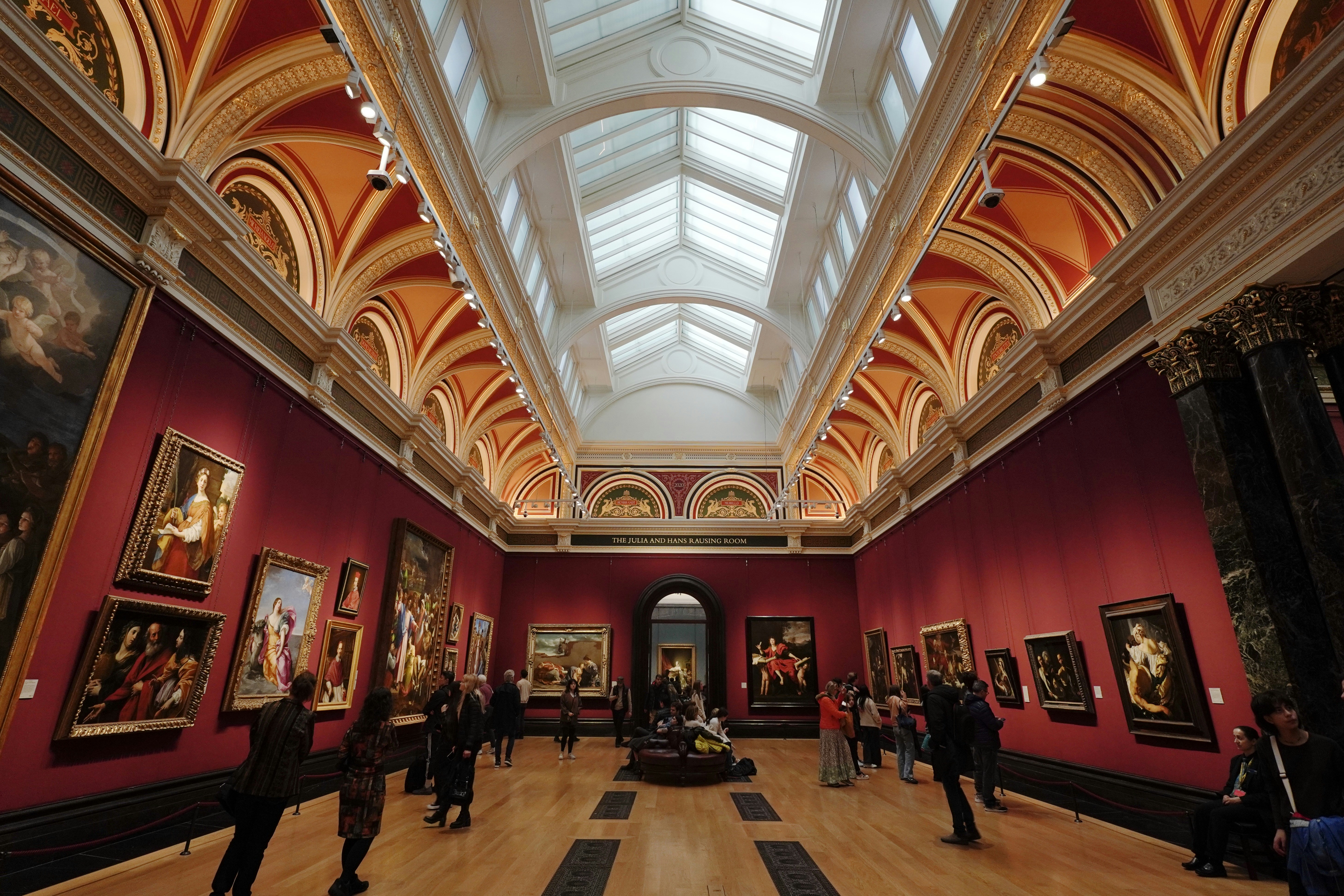 A large room filled with lots of paintings