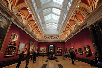 A large room filled with lots of paintings