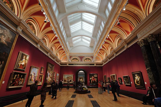 A large room filled with lots of paintings