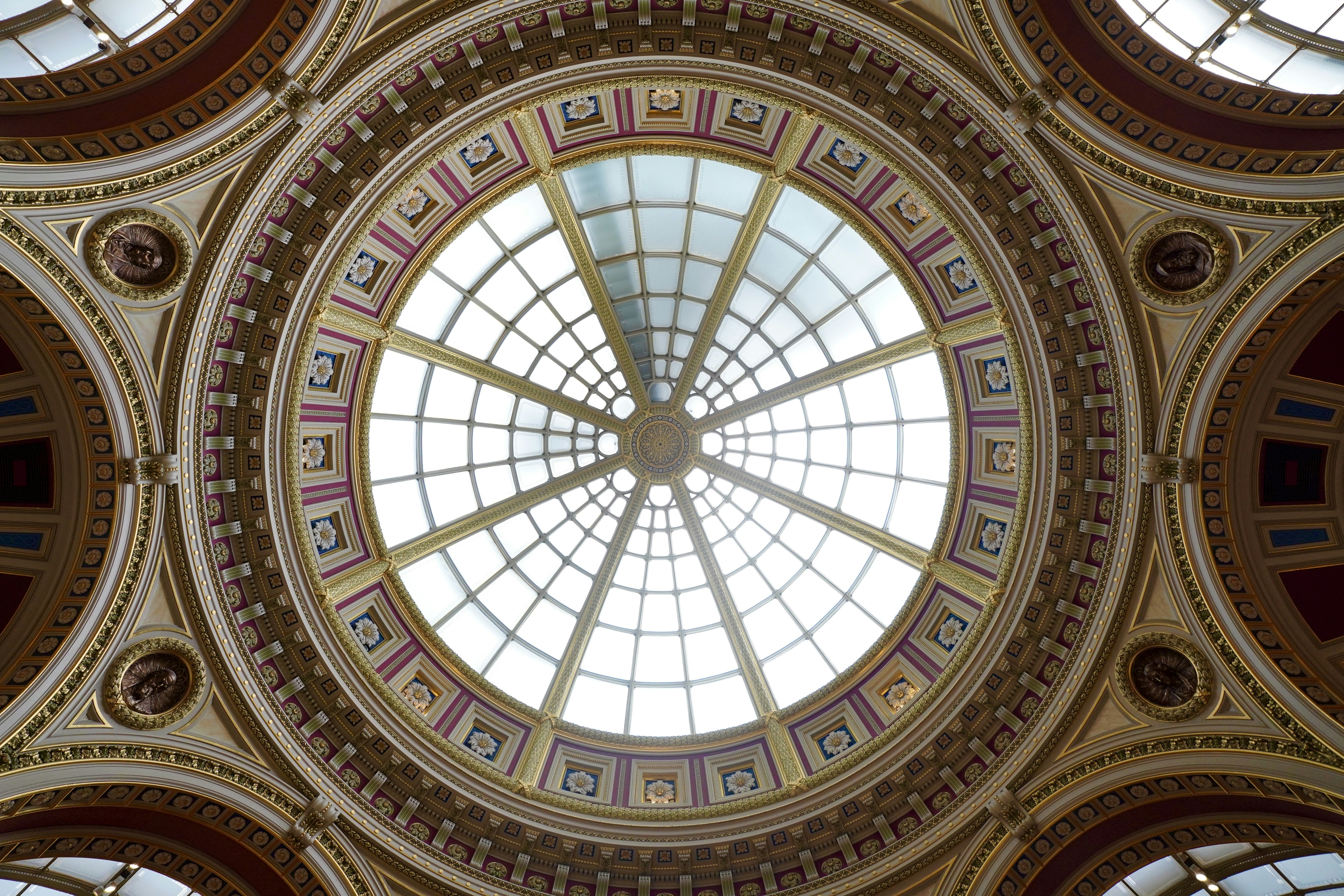 The ceiling of a building with a circular window