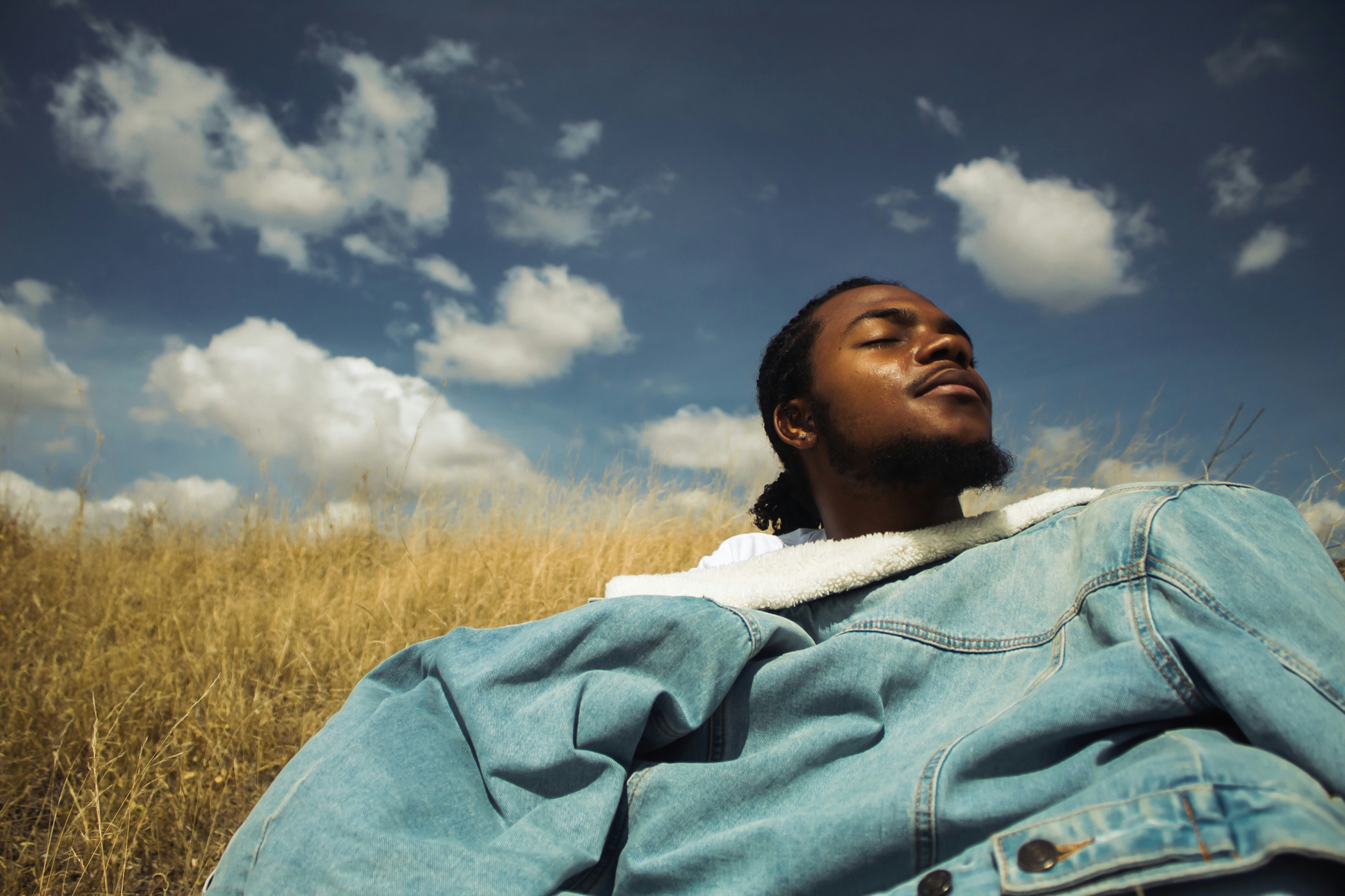 A man laying in a field of tall grass photo – Free Athi river Image on ...